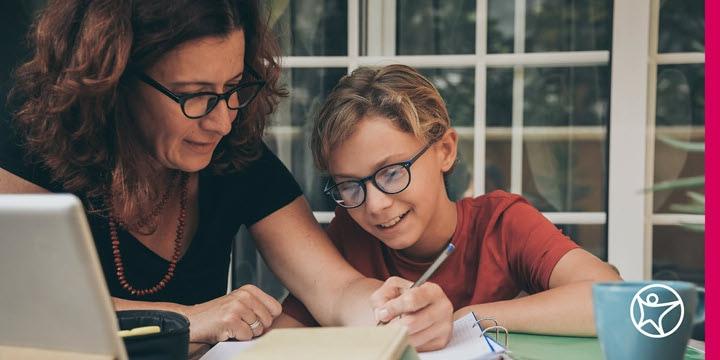 A mother helping her son with online school work